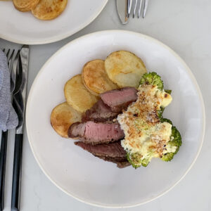 Seared Steak with Crispy Potatoes and Broccoli Cheese